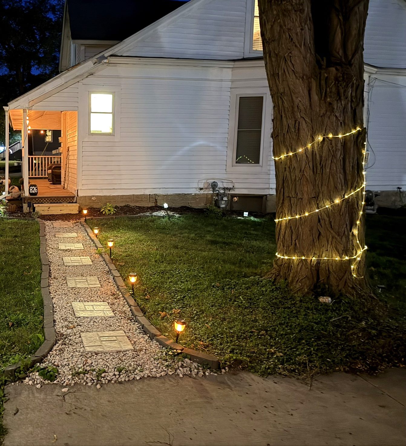 Lit walkway and string lights at dusk, 826 E Center Street
