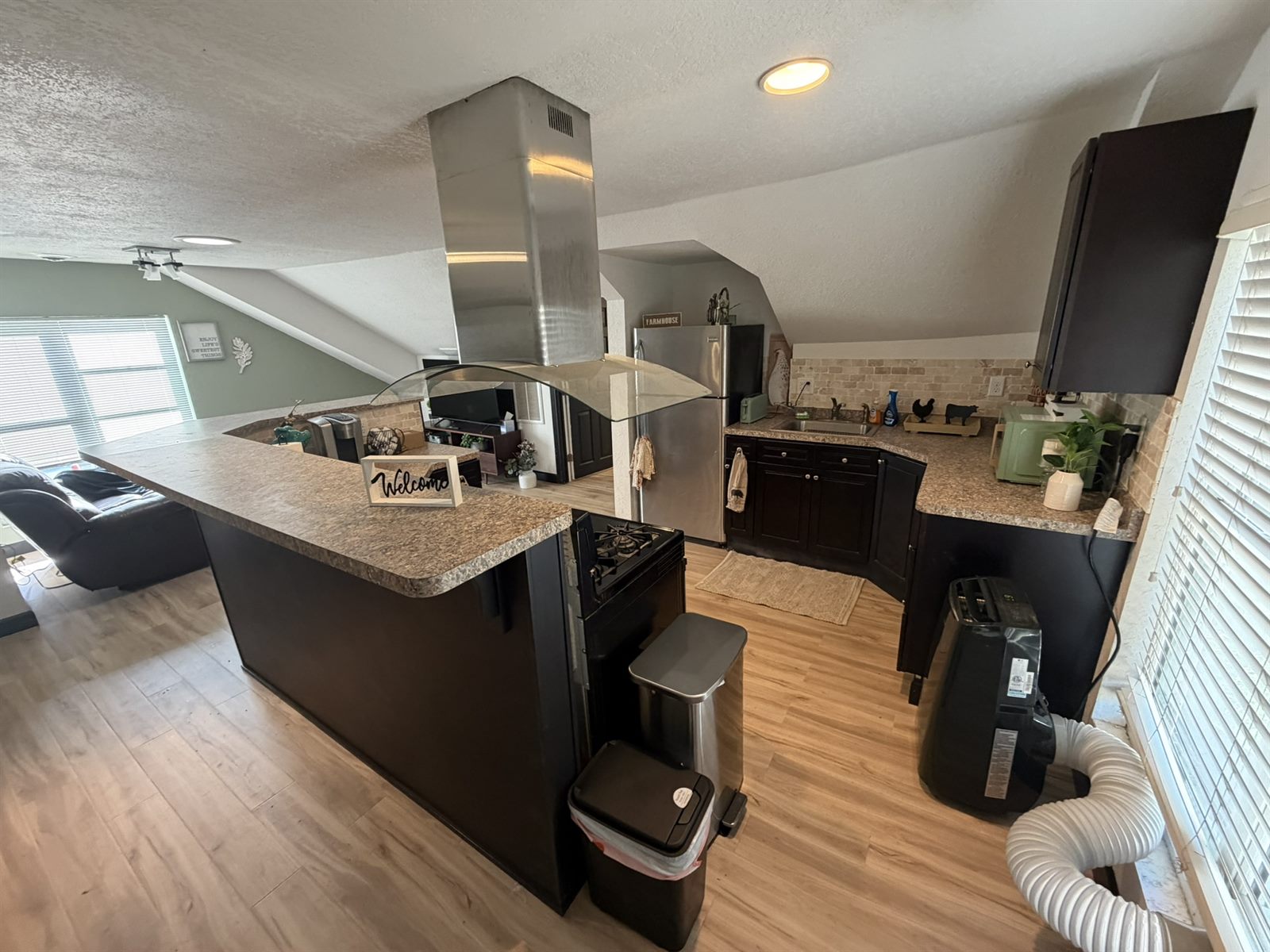 Rose's Barn Loft kitchen with an island, open to the living space under a vaulted ceiling