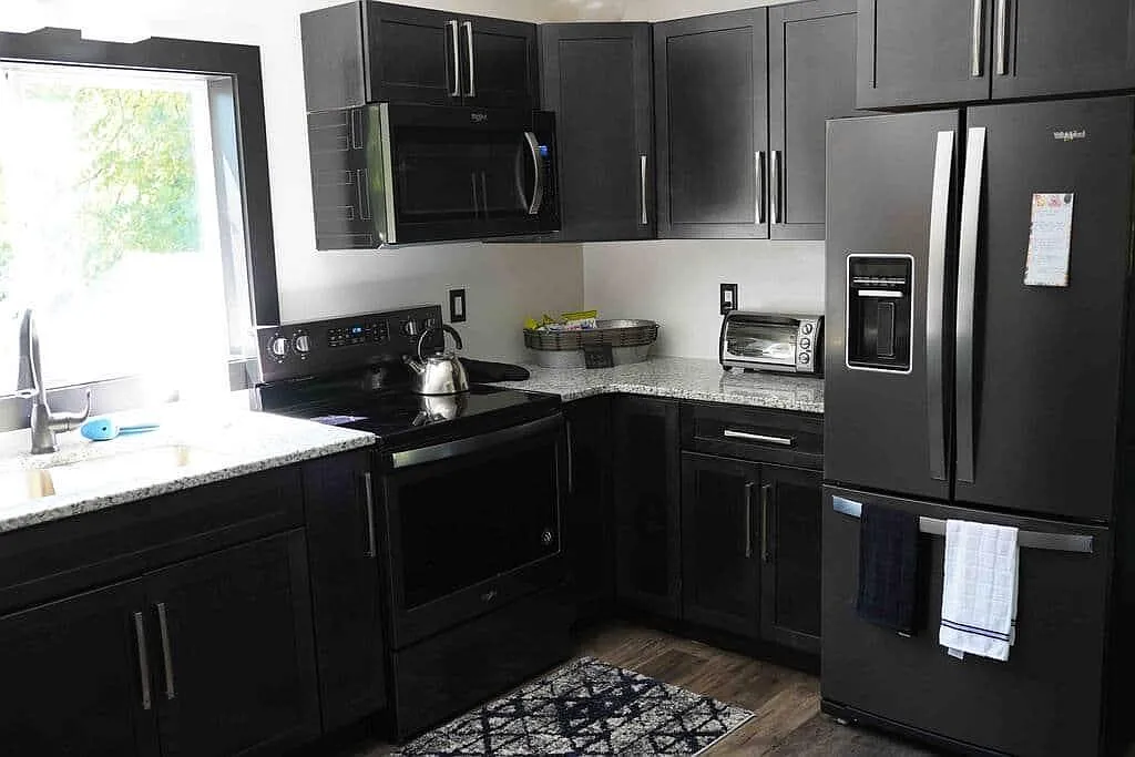 Rose's Loft kitchen with black stainless appliances and granite counters