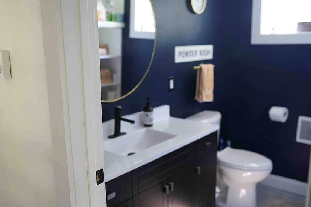 Powder room in Rose's Loft with deep navy walls