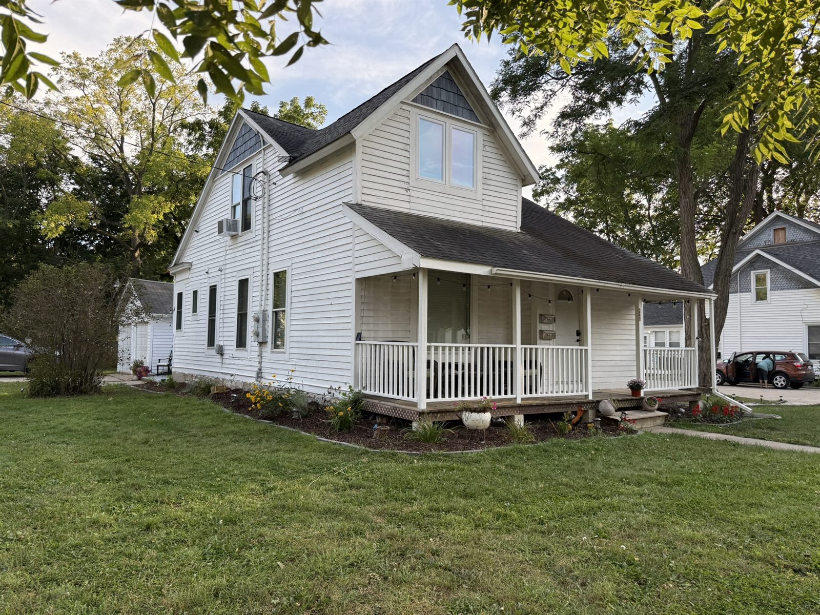 A white farmhouse at 826 E Center Street, part of Rose's Village in Rochester, Minnesota